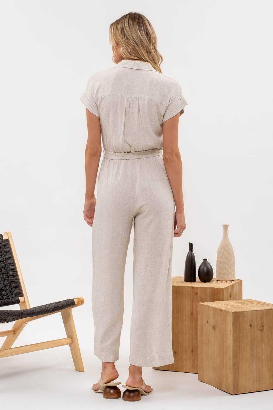 Back view of Button Down Belted Wide Leg Jumpsuit from J&J Shop Online displaying the elegant cut.