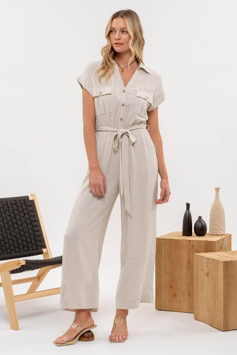 Side view of Button Down Belted Wide Leg Jumpsuit from J&J Shop Online highlighting the wide leg and belt.