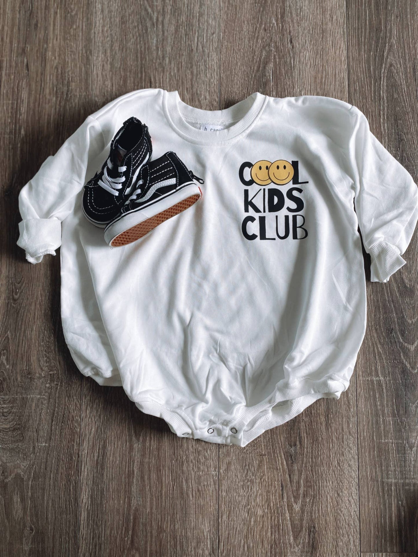 Cool Kids Club long-sleeve romper and black high-top sneakers from the Kids' Collection at J&J Shop Online, owned by 90 Day Fiancé stars Juan and Jessica