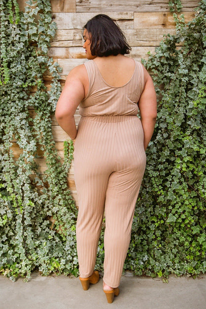 Cruiser Jumpsuit in Tan hanging, back view, available at J&J Shop Online.