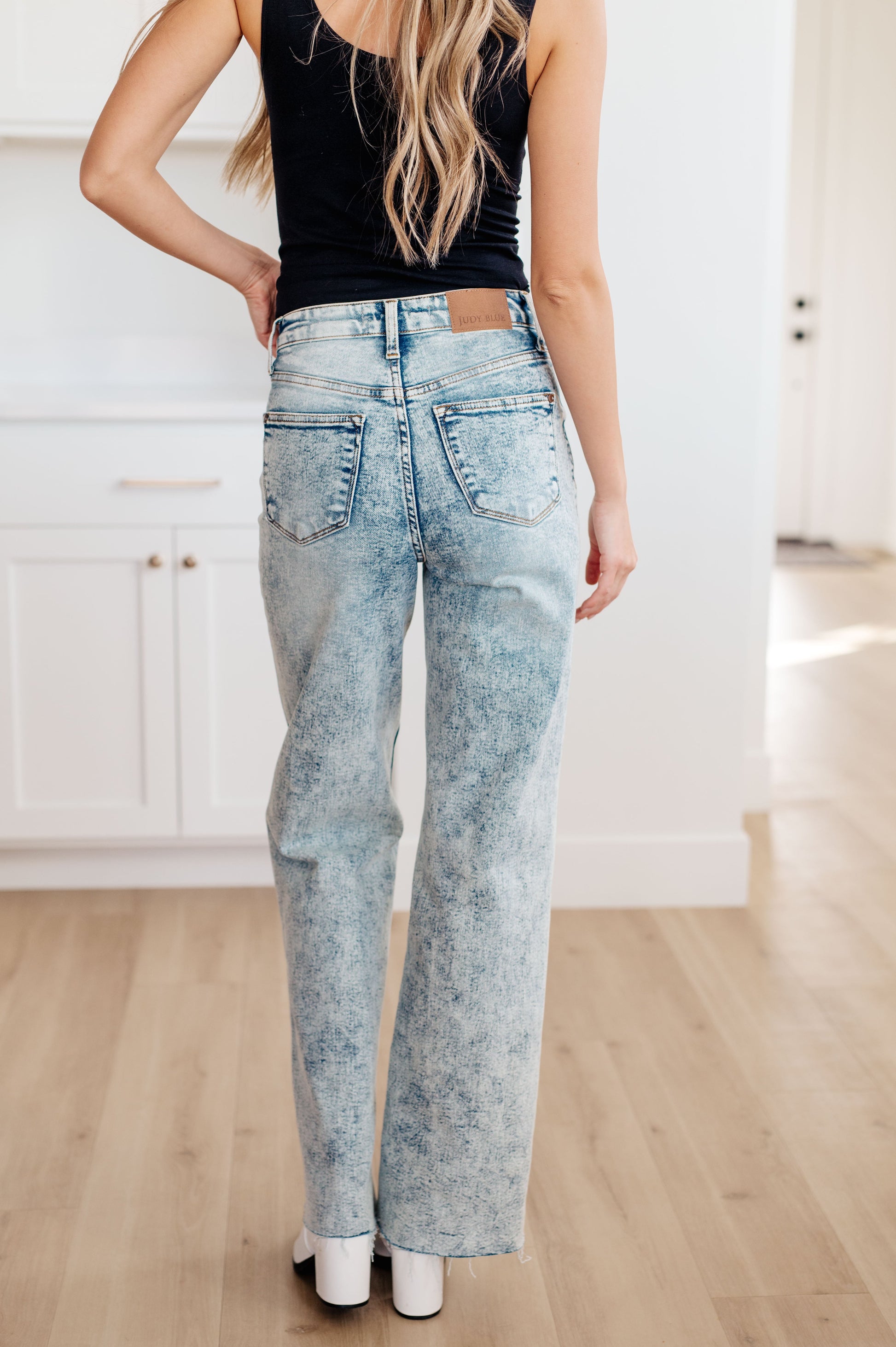 Model Krychele wearing the Dory High Waist Mineral Wash Raw Hem Wide Leg Jeans by Judy Blue in size 15/32, available at J&J, as seen on Jessica and Juan from 90 Day Fiancé.