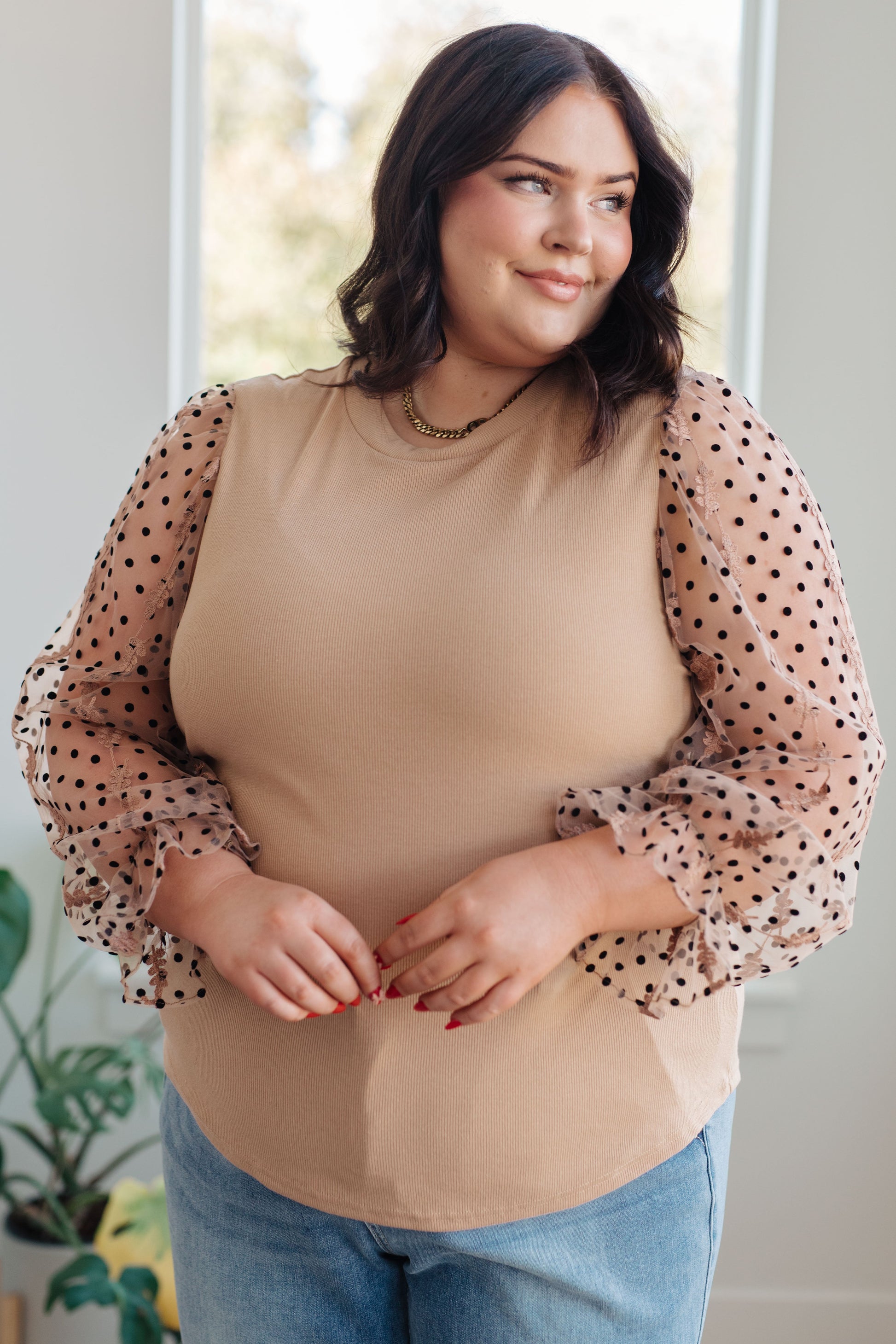 Front view of the Dots on My Sleeves Blouse, featuring sheer sleeves with velvet polka dots and an embroidered floral pattern, available at J&J, as seen on Jessica and Juan from 90 Day Fiancé.