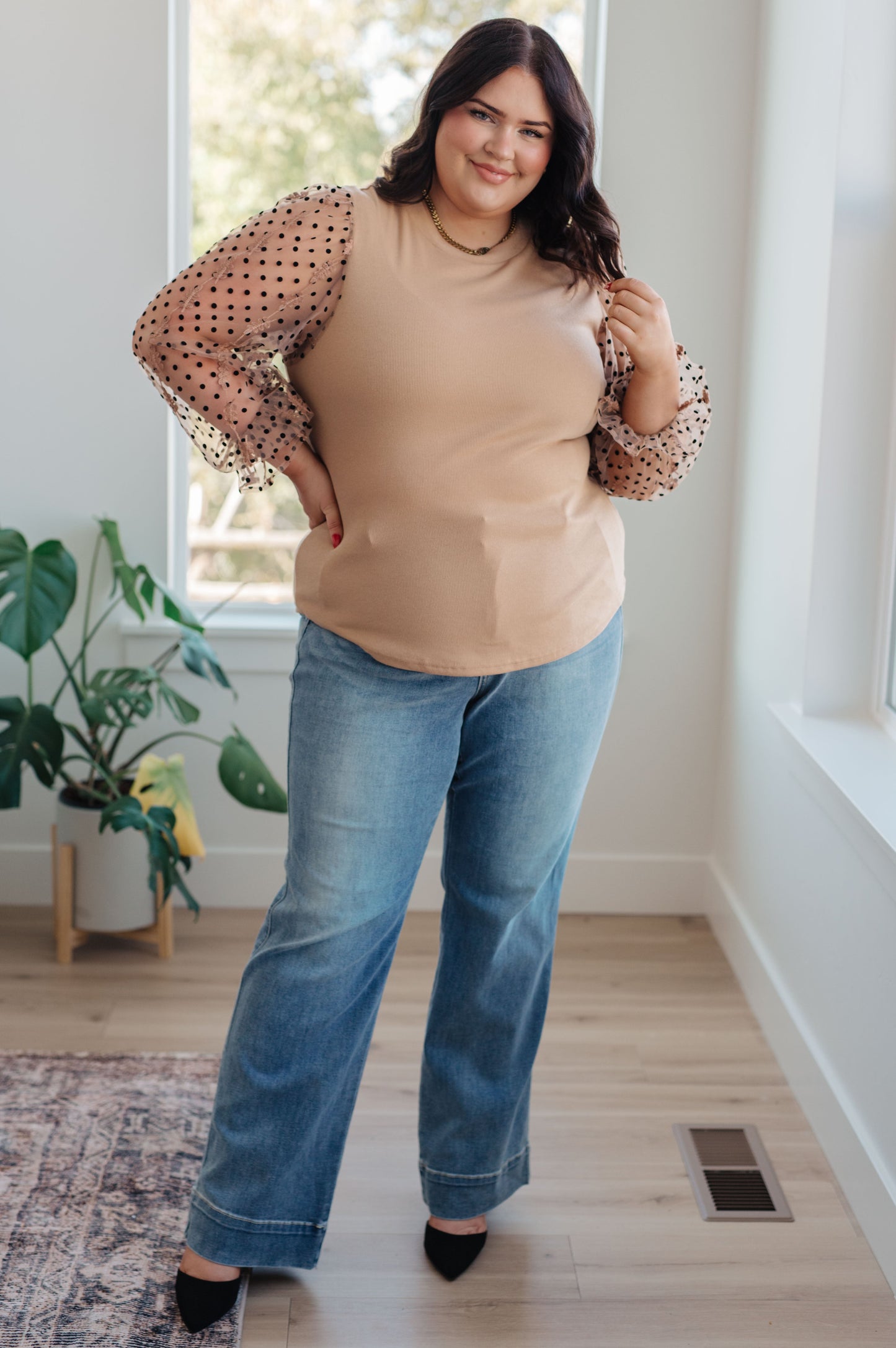 Model wearing the Dots on My Sleeves Blouse, side view, highlighting the unique sleeve details, available at J&J, as seen on Jessica and Juan from 90 Day Fiancé.