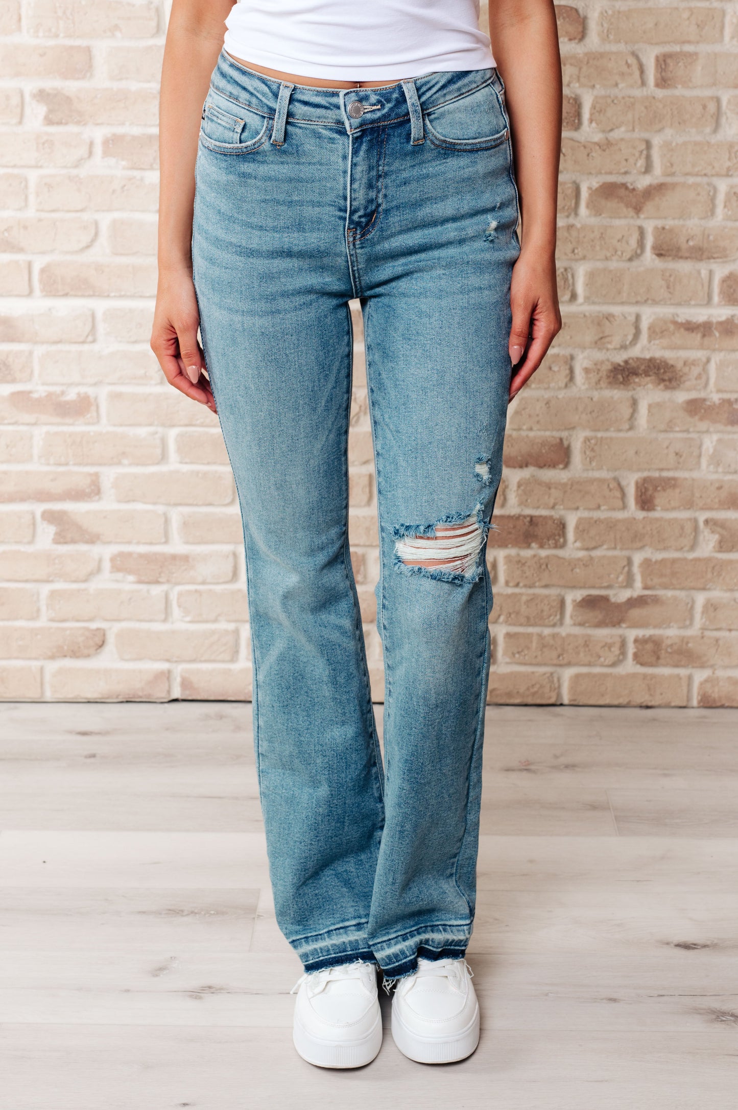 Front view of Isla Mid Rise Distressed Released Hem Bootcut Jeans from J&J Shop Online.