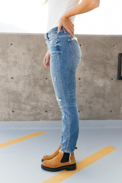 Judy Blue Boyfriend Fit Denim at J&J SHOP ONLINE, offering a relaxed fit with distressing details and frayed hem for a casual look.