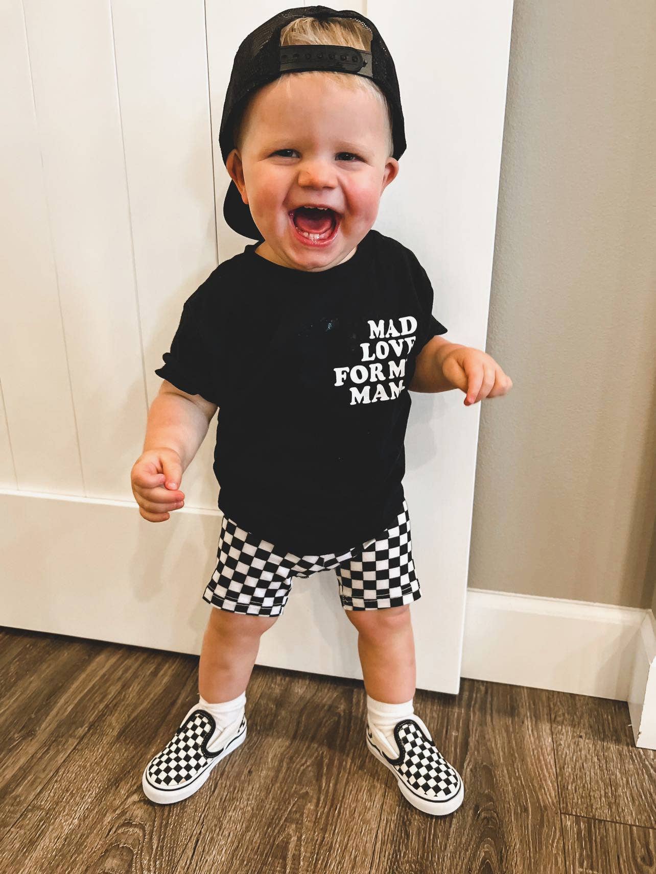 Smiling toddler in a black "Mad Love for My Mama" shirt, cute kids clothing by juan and jess from 90 day fiance 