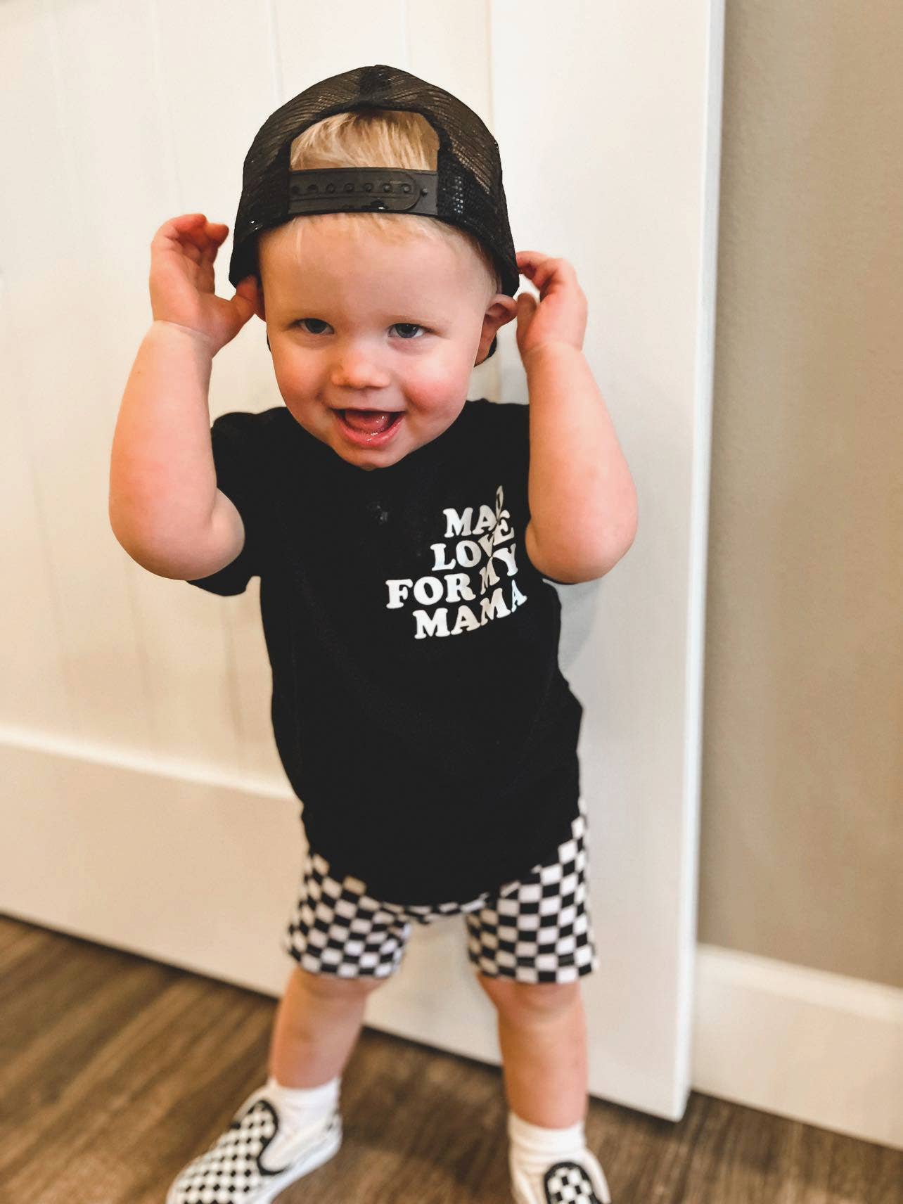 Smiling toddler in a black "Mad Love for My Mama" t-shirt, adorable kids fashion by juan and jess from 90 day fiance 