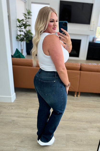 Model Kirra wearing the Muriel Mid Rise Control Top Classic Straight Jeans from J&J Shop Online in size 13/31, showcasing the jeans on a larger size.