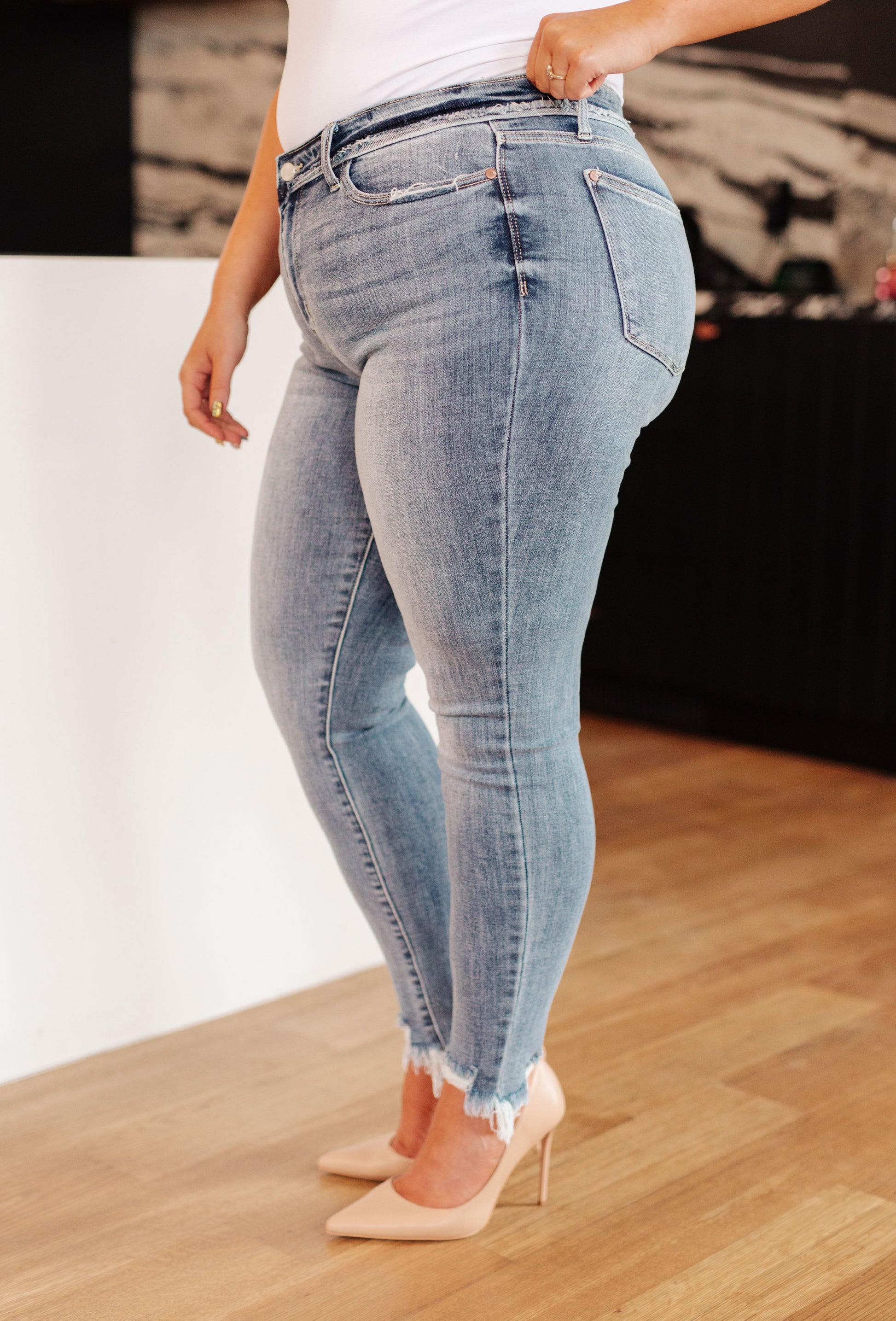 Model Kirra wearing Sherry Mid Rise Skinny Jeans from J&J SHOP ONLINE, size 13/31, highlighting the skinny fit and raw hem.