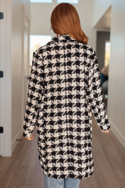 Detailed view of the functional button closure on the Monochromatic Moment Houndstooth Coat from J&J Shop Online.