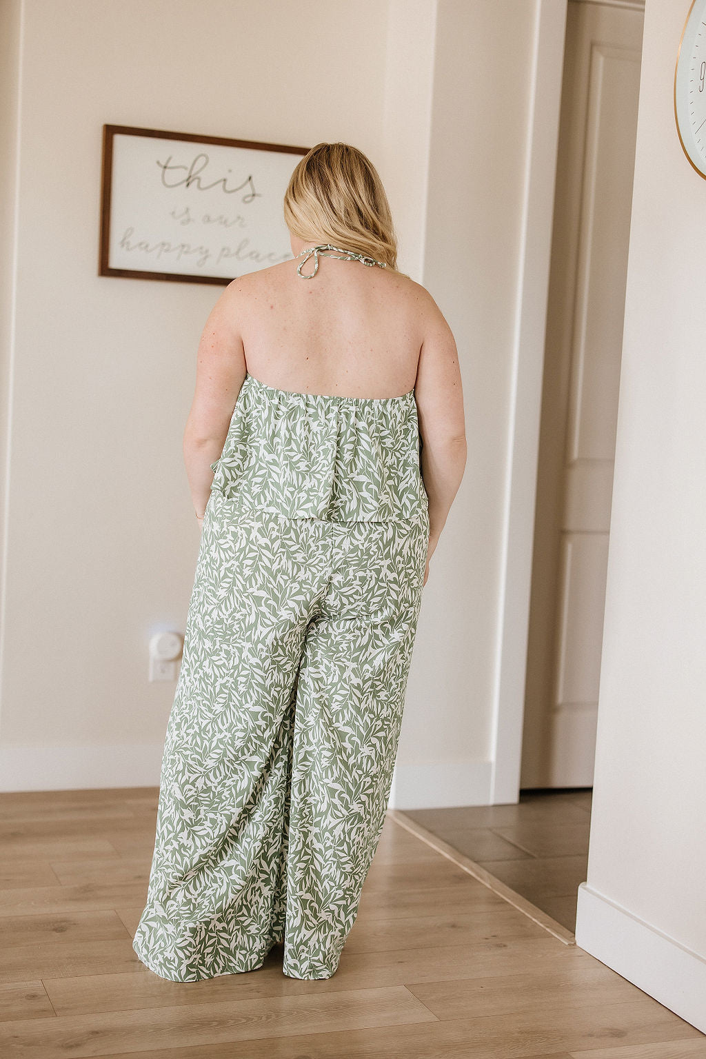 Back view of the My Next Adventure Jumpsuit from J&J Shop Online, highlighting the overlay bodice and wide leg design.