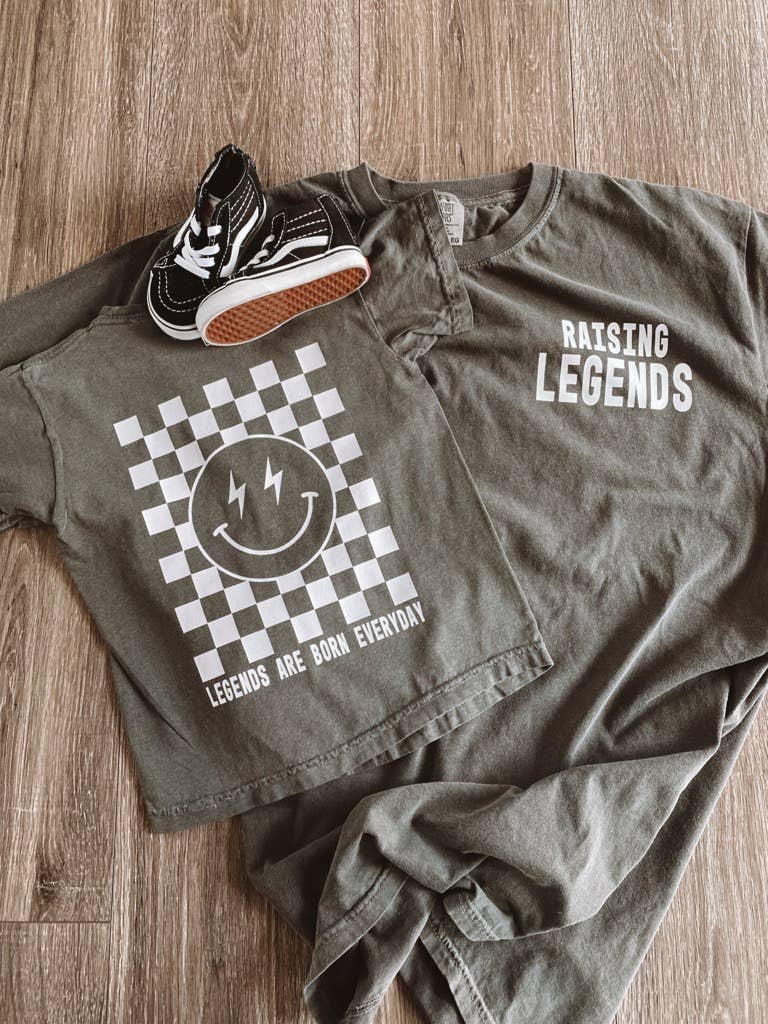 Raising Legends Shirt from J&J SHOP ONLINE, featuring a powerful slogan on a Comfort Colors tee with a washed, lived-in feel. Supports IVF scholarship program.