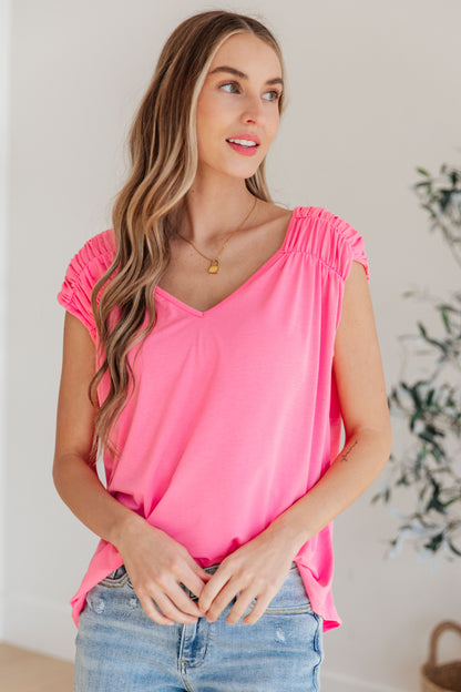 Ruched Cap Sleeve Top in Neon Pink from J&J SHOP ONLINE, featuring gathered elastic shoulders and a tie back.