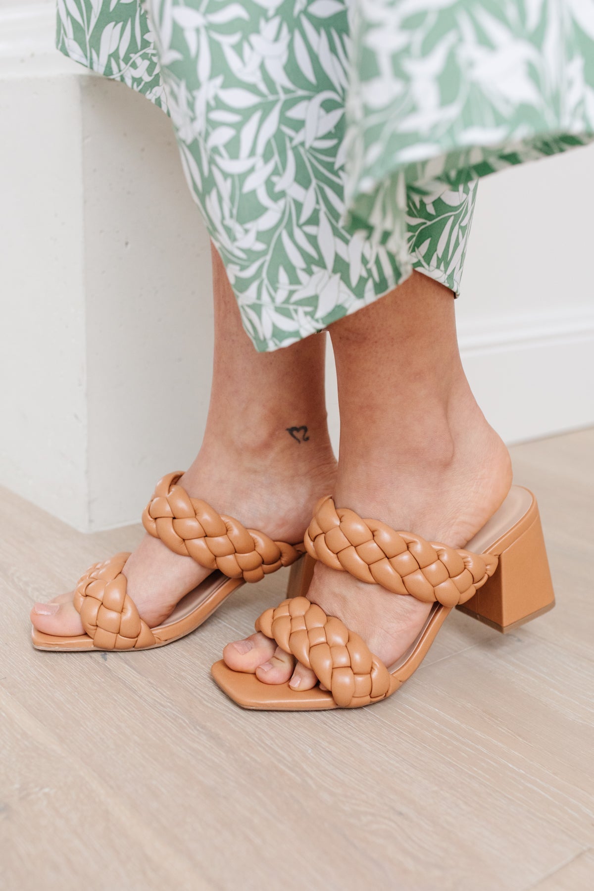 Detailed view of the 2.5" heel on Maya Braided Heels in Tan from J&J Shop Online, highlighting the slight heel and faux leather finish.