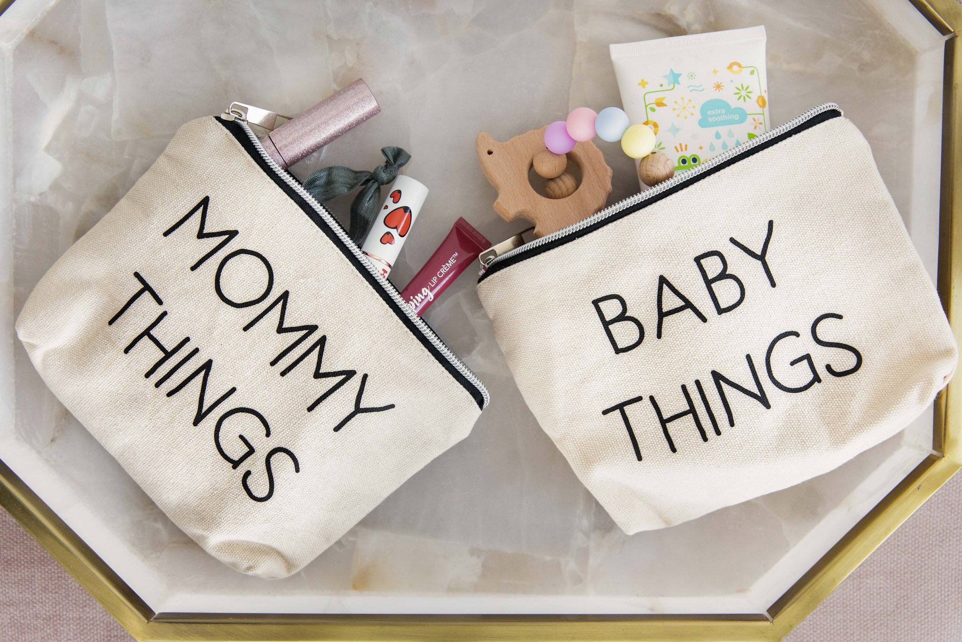 Close-up view of Pearhead’s mommy and baby canvas pouches set, featuring black prints, from J&J Shop Online