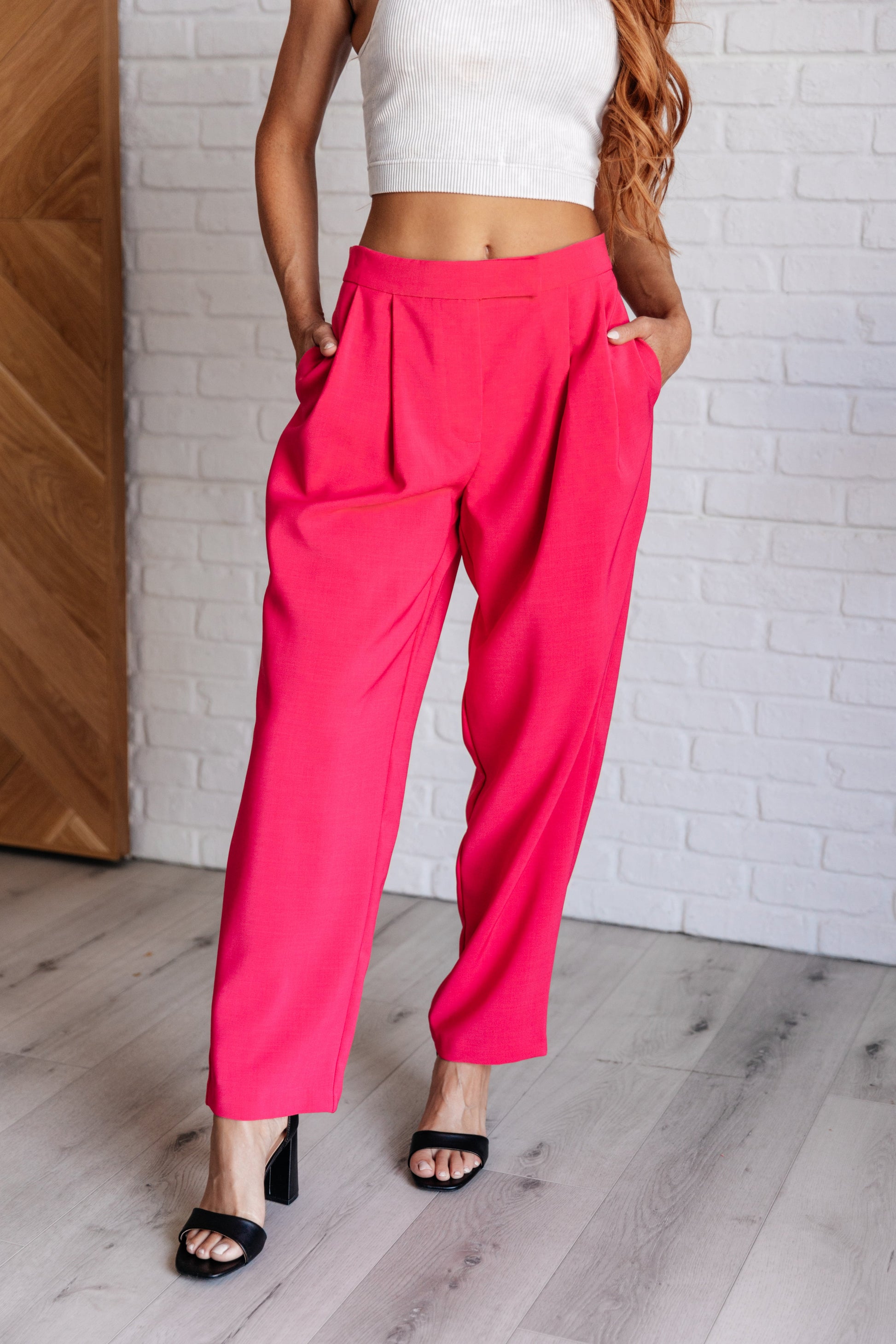 Front view of Vigilante Stuff Pleated Trousers in Hot Pink, showcasing pleated details and banded waistband from J&J Shop.