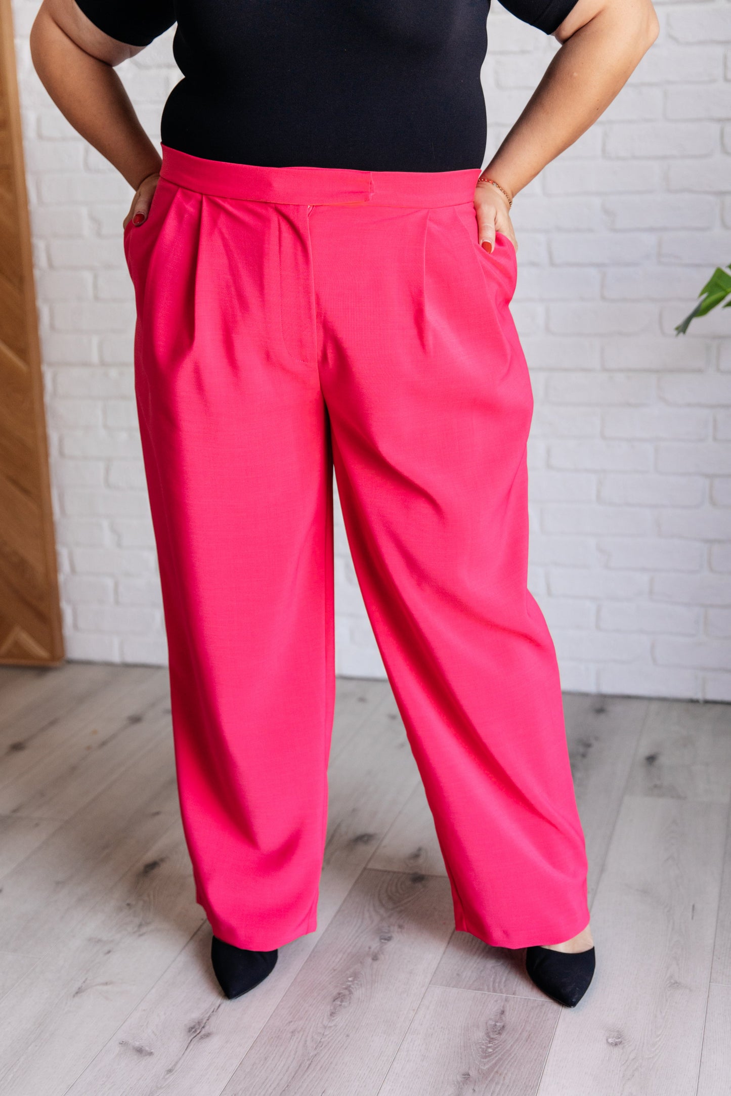 Side view of the Hot Pink Vigilante Stuff Pleated Trousers, highlighting the straight-leg fit and pleated design from J&J Shop.