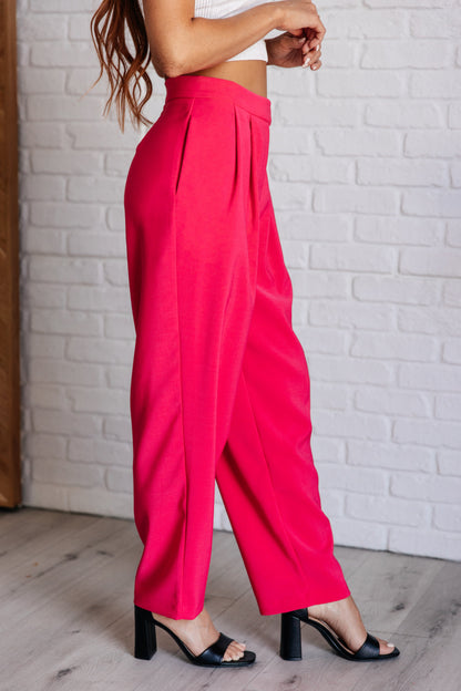 Straight leg view of the Hot Pink Vigilante Stuff Pleated Trousers, emphasizing the clean lines and pleated details from J&J Shop.